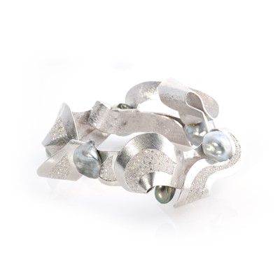Lot 269 - Ken Bolan and Marinette Domon: a white gold, Tahitian pearl and diamond 'Baroque' bangle