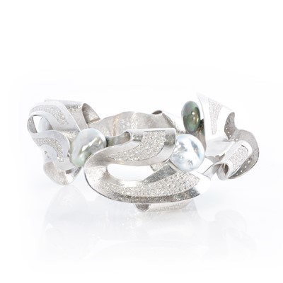Lot 269 - Ken Bolan and Marinette Domon: a white gold, Tahitian pearl and diamond 'Baroque' bangle