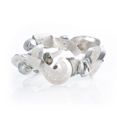 Lot 269 - Ken Bolan and Marinette Domon: a white gold, Tahitian pearl and diamond 'Baroque' bangle