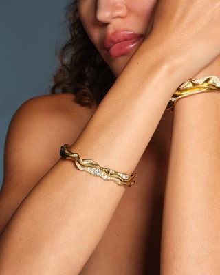 Lot 259 - Ken Bolan and Marinette Domon: a diamond 'Touche de Soie' cuff bangle