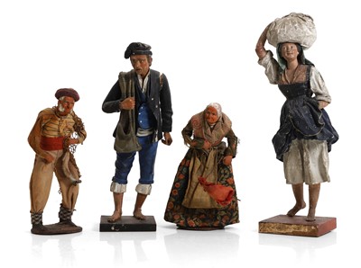Lot 329 - A pair of carved wood, gesso and clay artisan figures