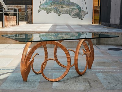 Lot 442 - An 'Antelope' patinated and glass dining table