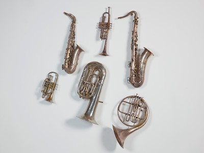 Lot 45 - Six brass and silvered musical instruments