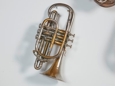 Lot 45 - Six brass and silvered musical instruments