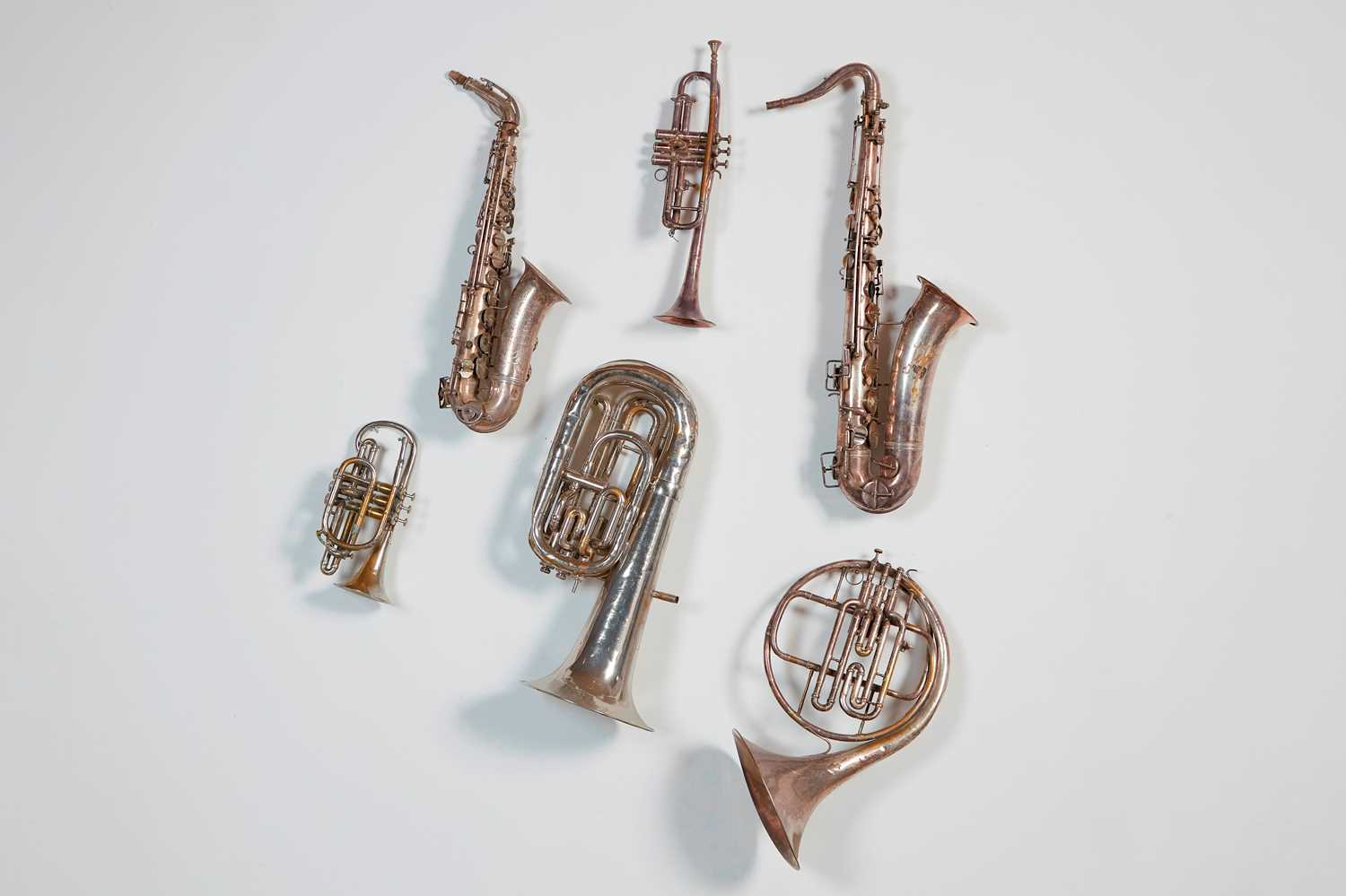 Lot 45 - Six brass and silvered musical instruments