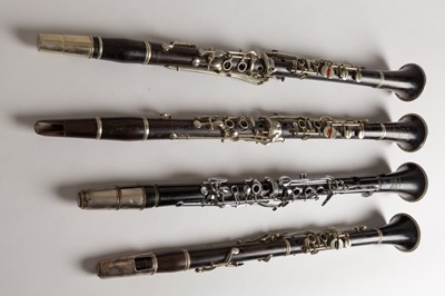 Lot 47 - Four wood and silvered clarinets