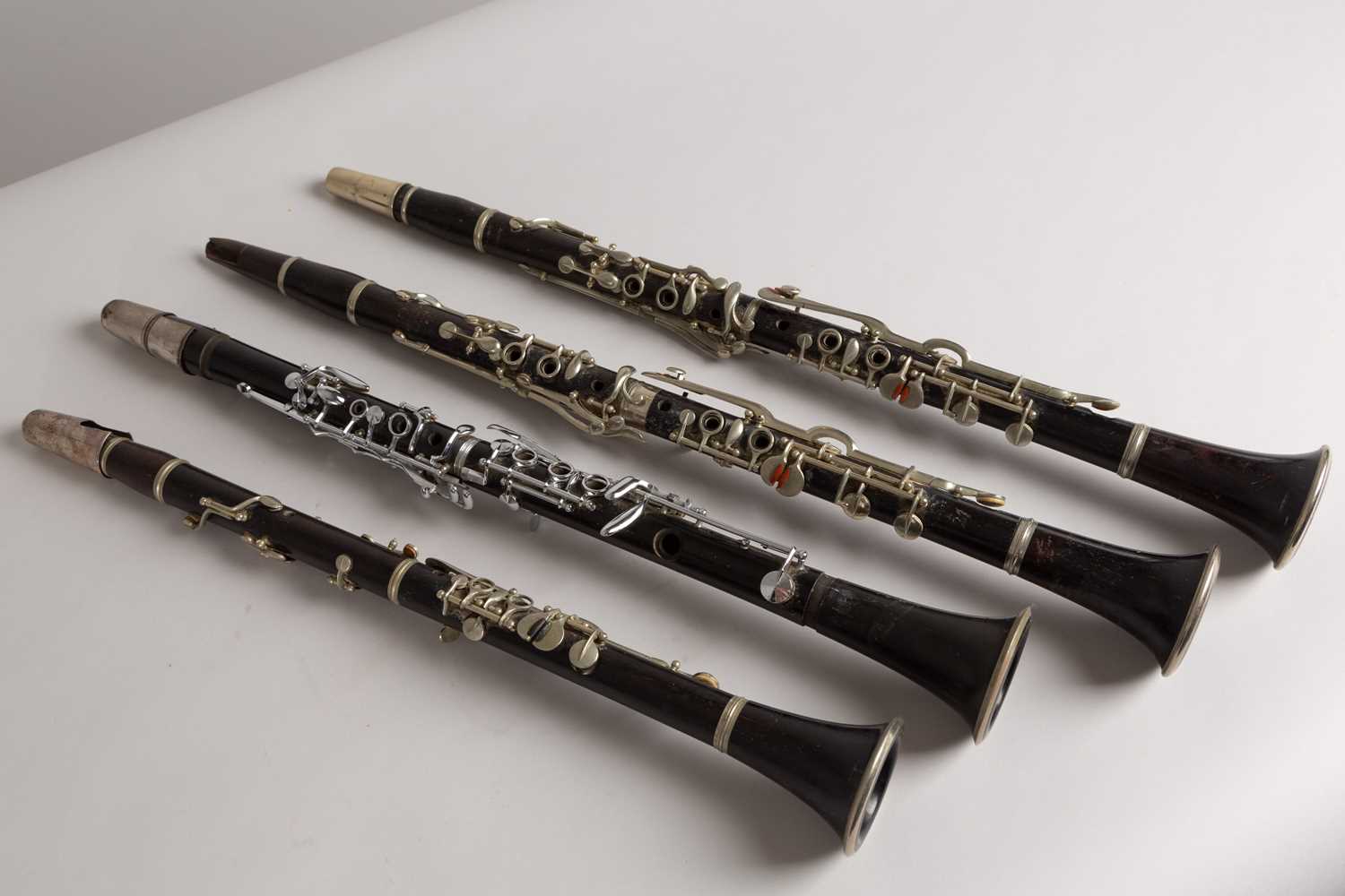 Lot 47 - Four wood and silvered clarinets