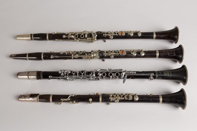Lot 47 - Four wood and silvered clarinets