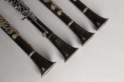 Lot 47 - Four wood and silvered clarinets