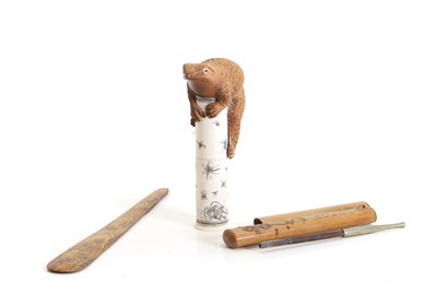 Lot 146 - A Japanese boxwood and bone okimono / scroll holder