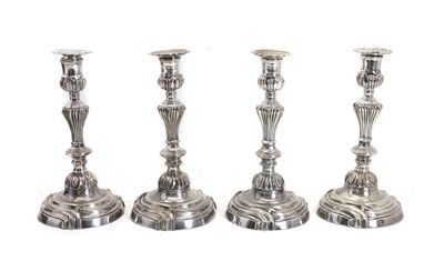 Lot 36 - A set of four French electroplated Rococo style candlesticks
