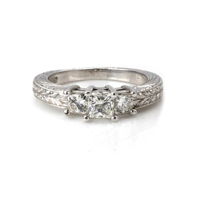 Lot 244 - A white gold three stone diamond ring