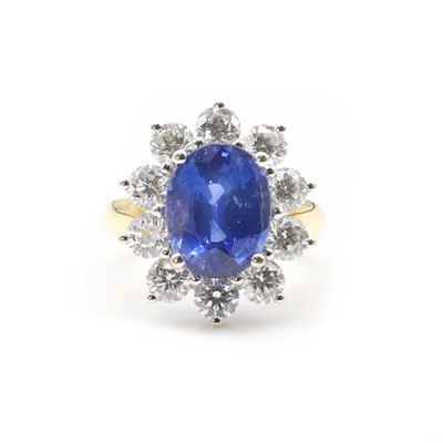 Lot 244 - An 18ct gold Sri Lankan sapphire and diamond oval cluster ring