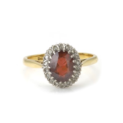 Lot 122 - An 18ct gold garnet and diamond cluster ring