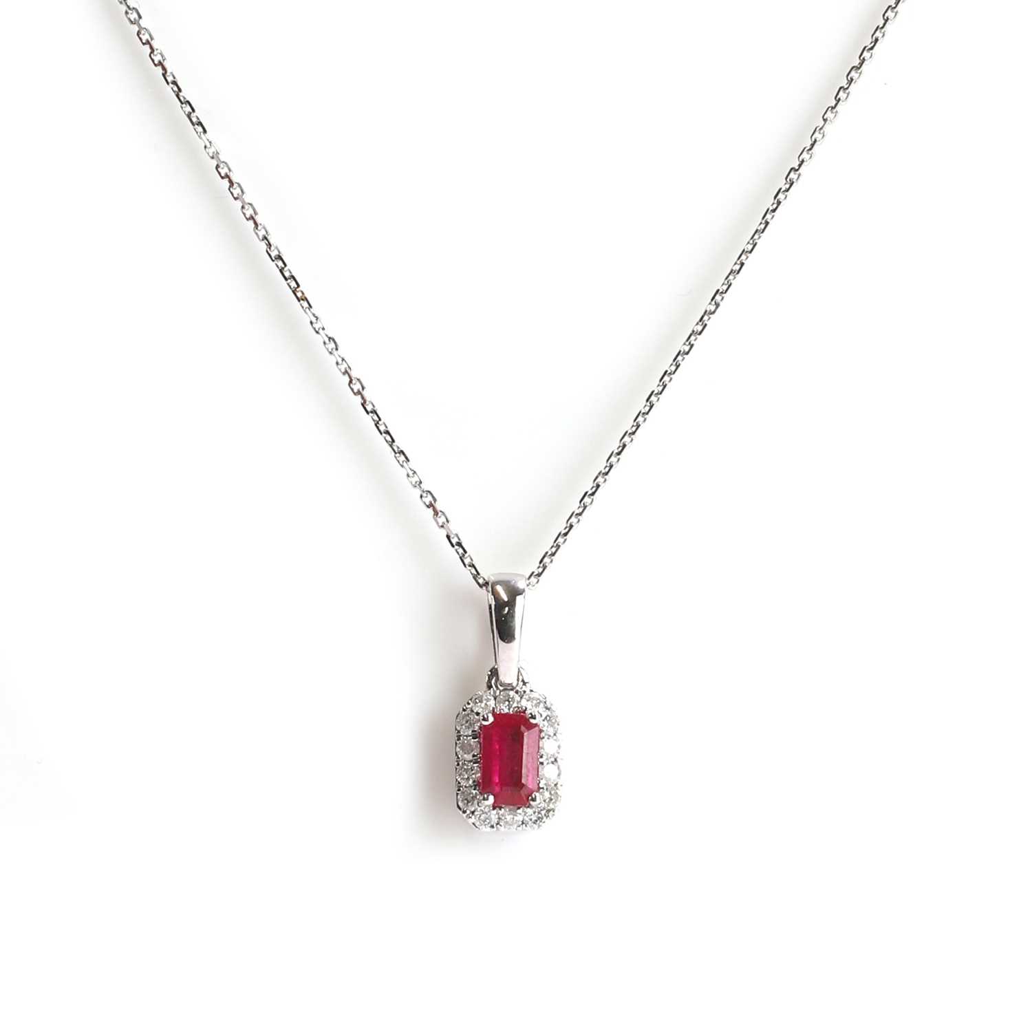 Lot 123 - A 9ct white gold ruby and diamond cluster pendant