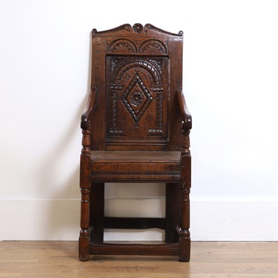 Lot 399 - A carved oak wainscote armchair