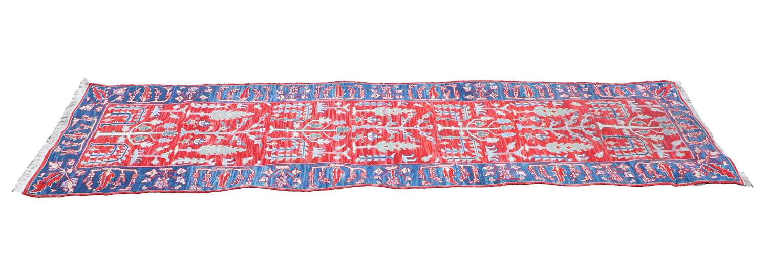 Lot 309 - A hand knotted Persian red ground runner