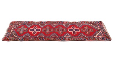 Lot 306 - A hand knotted Persian style red ground runner