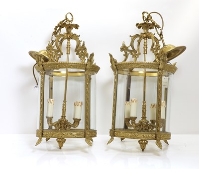 Lot 338 - A pair of brass framed hall lanterns