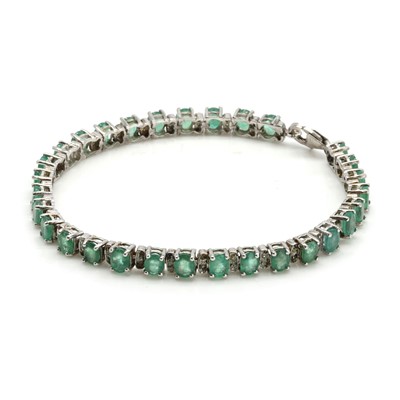 Lot 272 - An emerald and diamond line bracelet