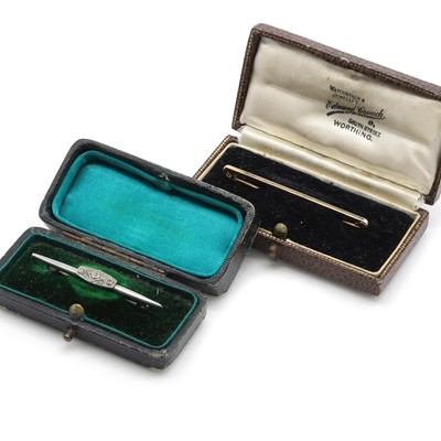 Lot 306 - A cased gold bar brooch and a white metal bar brooch