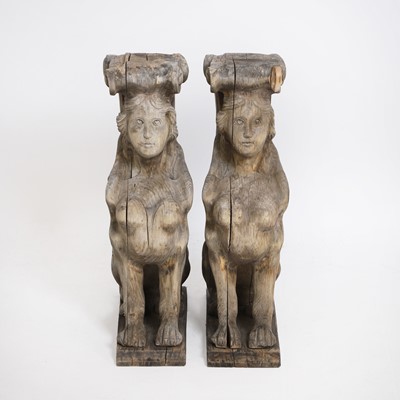 Lot 140 - A pair of carved wooden sphinx caryatids