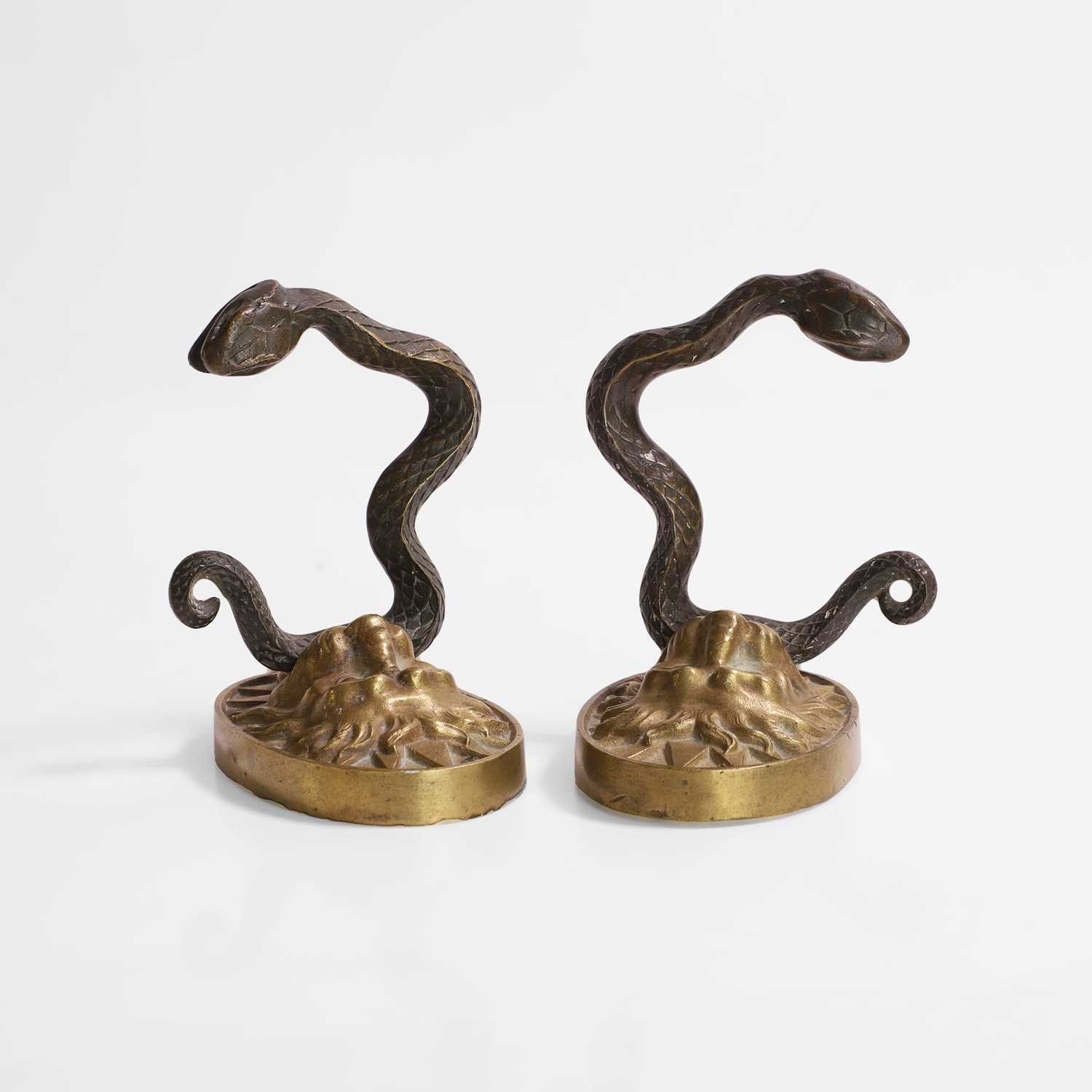 Lot 43 - A pair of serpent and lion curtain tie-backs