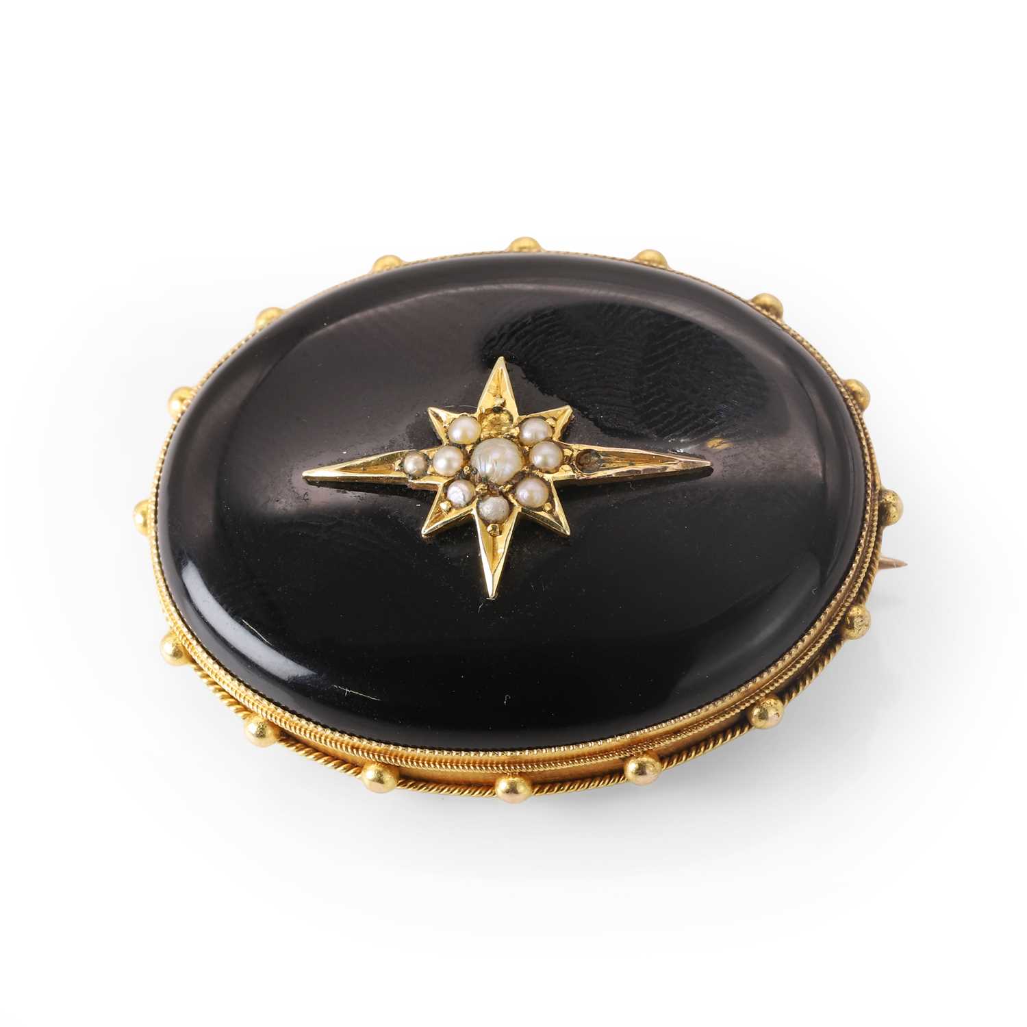 Lot 7 - A Victorian onyx and split pearl mourning brooch