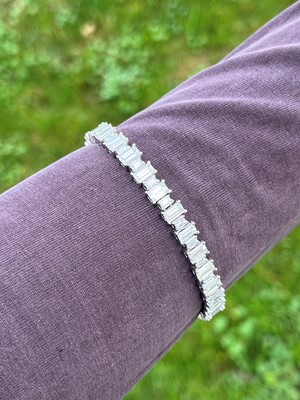 Lot 231 - A platinum and diamond line bracelet