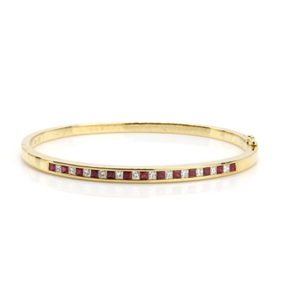 Lot 190 - An 18ct gold ruby and diamond bangle, retailed by Mappin & Webb