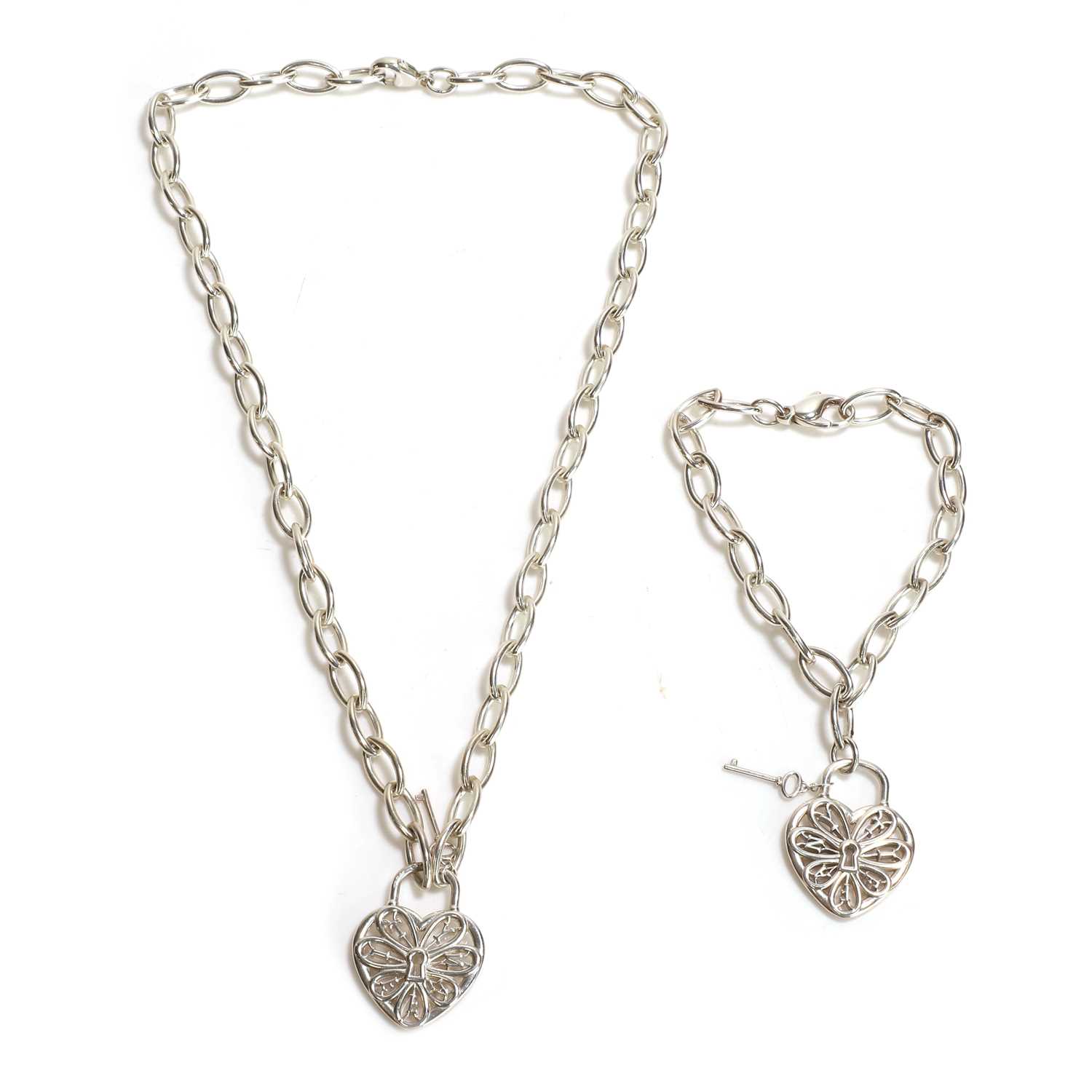 Lot 251 - A sterling silver heart key pendant and bracelet set, by Tiffany & Co.