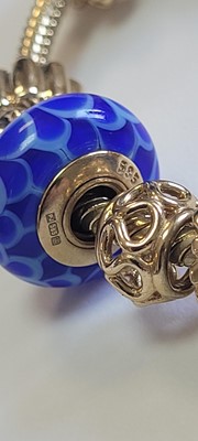Lot 256 - A 14ct gold charm bracelet by Pandora and two bracelets by Thomas Sabo