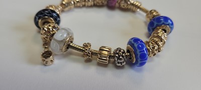Lot 256 - A 14ct gold charm bracelet by Pandora and two bracelets by Thomas Sabo