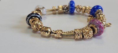 Lot 256 - A 14ct gold charm bracelet by Pandora and two bracelets by Thomas Sabo