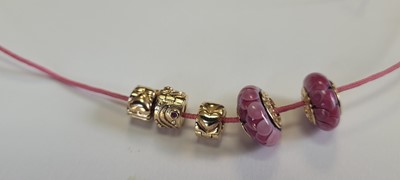 Lot 256 - A 14ct gold charm bracelet by Pandora and two bracelets by Thomas Sabo