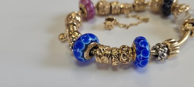 Lot 256 - A 14ct gold charm bracelet by Pandora and two bracelets by Thomas Sabo