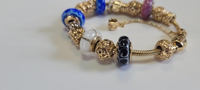 Lot 256 - A 14ct gold charm bracelet by Pandora and two bracelets by Thomas Sabo