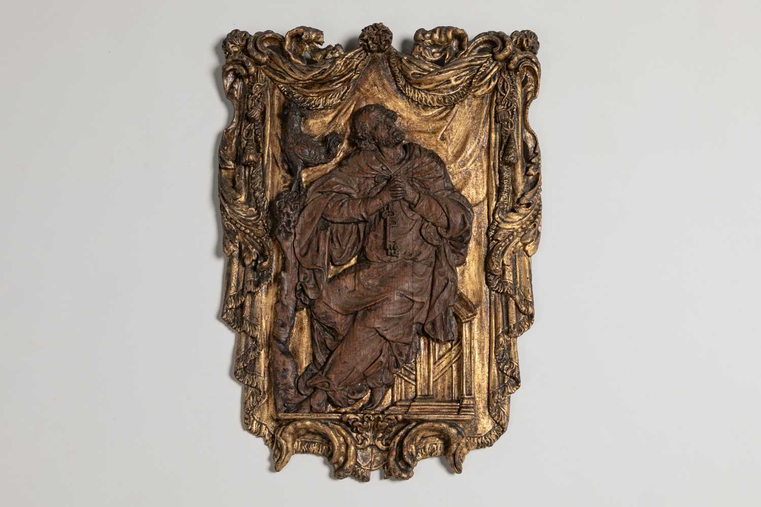 Lot 239 - An oak and giltwood panel of St Peter and the Rooster