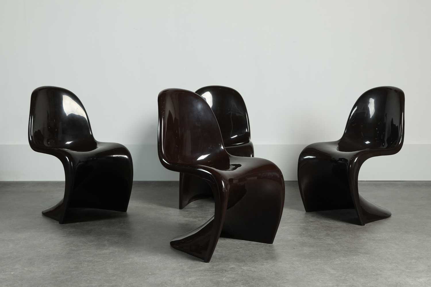 Lot 214 - A set of four brown fibreglass 'S' chairs