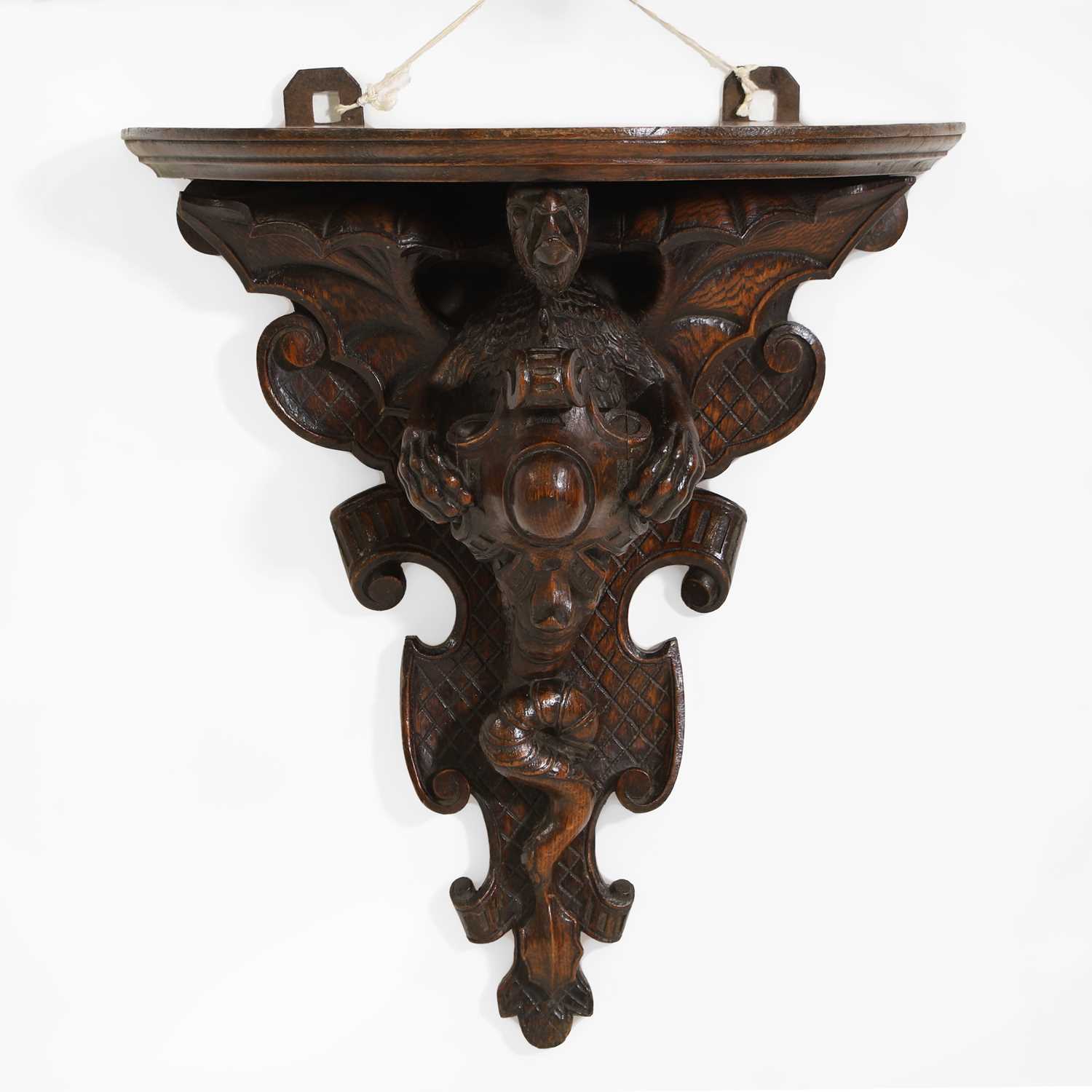 Lot 58 - An oak Arts & Crafts carved wall bracket
