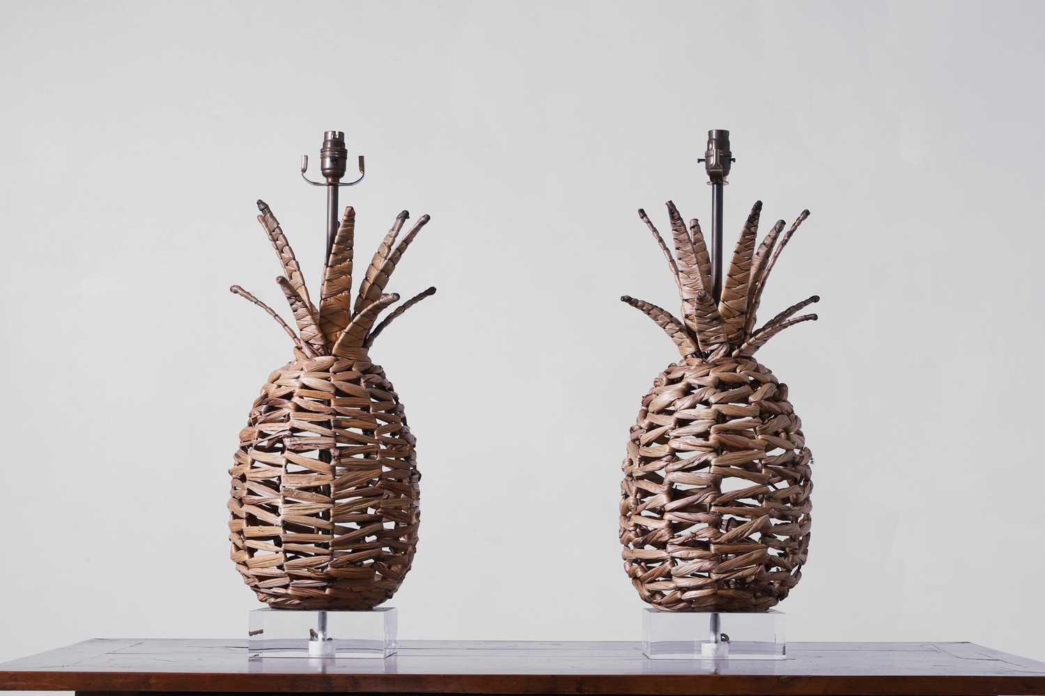 Lot 544 - A pair of woven rattan 'Ananas' table lamps by Paolo Moschino
