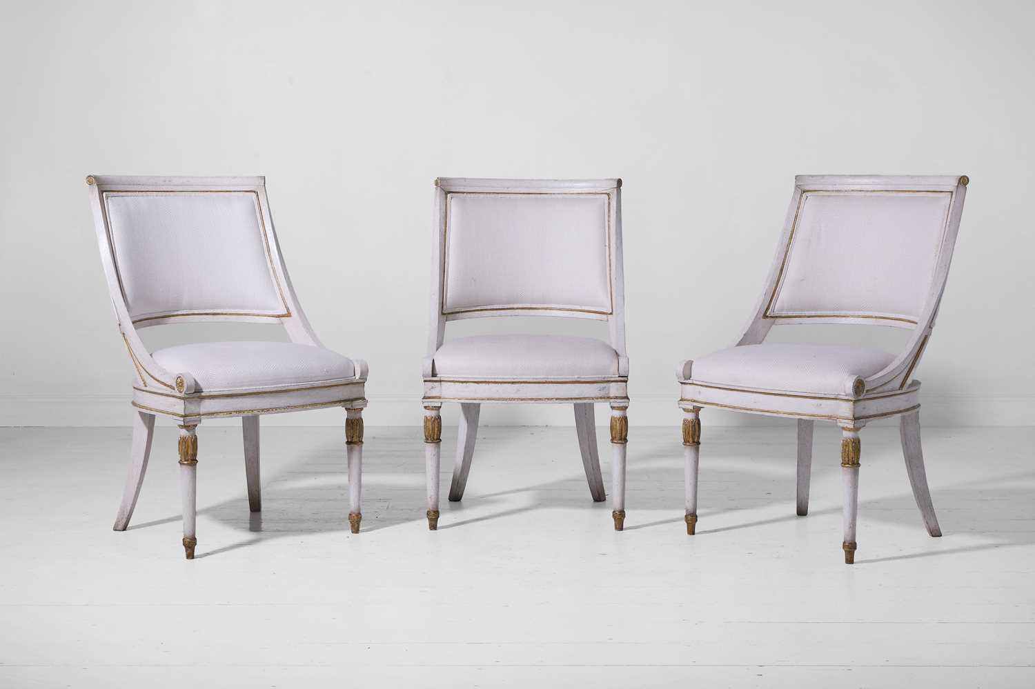 Lot 547 - A set of three Empire-style painted and parcel-gilt wooden tub chairs