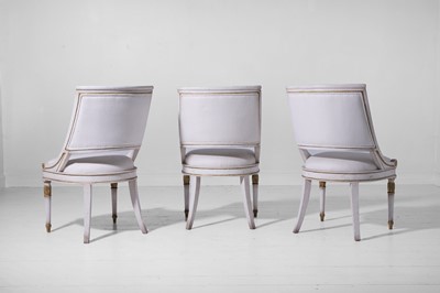 Lot 547 - A set of three Empire-style painted and parcel-gilt wooden tub chairs