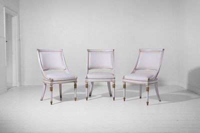 Lot 547 - A set of three Empire-style painted and parcel-gilt wooden tub chairs