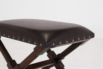 Lot 536 - A leather and stained wooden 'X' frame stool