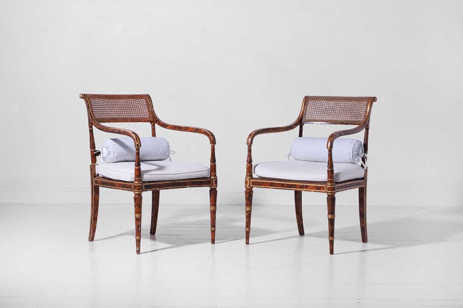 Lot 340 - A pair of Regency-style painted and parcel-gilt beech elbow chairs