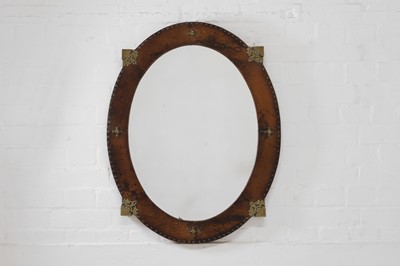 Lot 339 - A leather and brass oval mirror