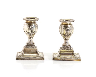 Lot 36 - A pair of Edwardian silver candlesticks