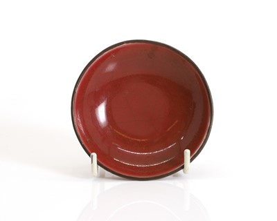 Lot 103 - A Chinese red-glazed saucer