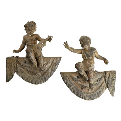 Lot 234A - A pair of patinated brass putti